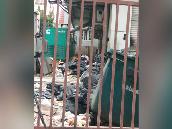 Waste material seen dumped behind the fast-food outlet in Mehdipatnam. Photo/ANI
