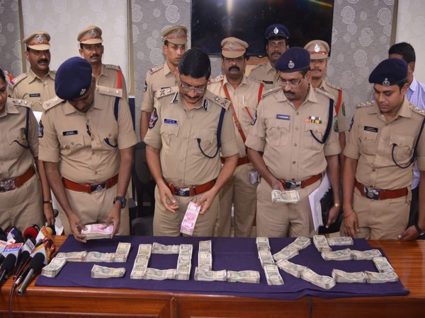 Police officers with the recovered money in Visakhapatnam on Saturday. 