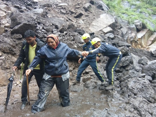 SDRF team helping out a woman pilgrim to cross the muddy track on Kailash Mansarovar Yatra. Photo/ANI