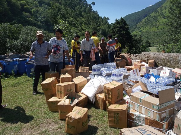 Relief workers with bottled water in Uttarakashi on Friday. 