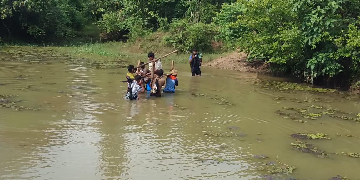 DRG personnel carrying the injured Maoist in Dantewada, Chhattisgarh. 