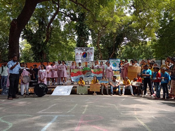 School students holding placards at Jantar Mantar