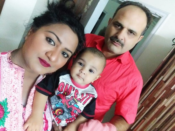 Gonila Gill, 38, with her husband and child