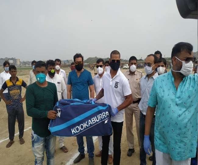 Opening batsman Shikhar Dhawan gits cricket kits to children at a refugee camp in Delhi 