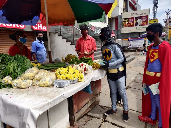Activists in Superhero costumes distributing pamphlets about Coronavirus awareness