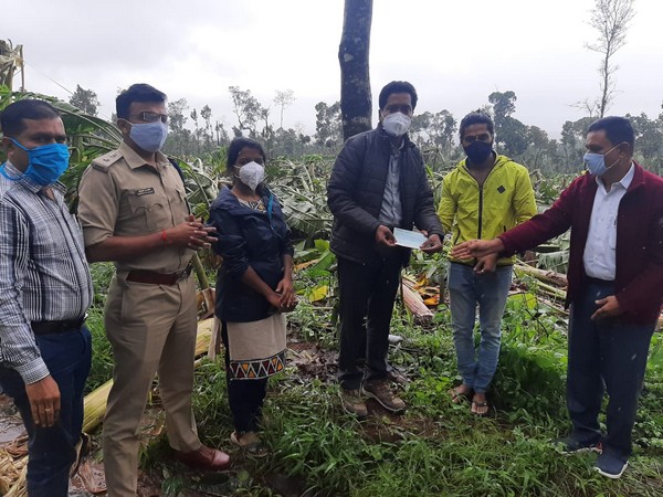 Karnataka: Government officials giving the cheque to Chikmagalur farmer A Rajanna [photo/ANI]