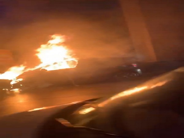 Four people had a narrow escape as their vehicle went up in flames in Hyderabad (Photo/ANI)