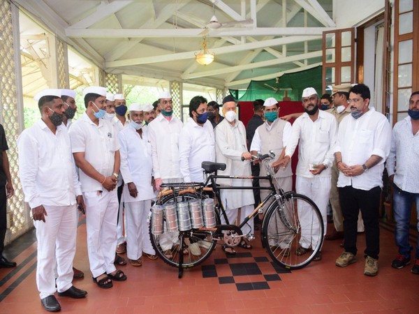 Maharashtra Governor Bhagat Singh Koshyari with several dabbawalas at Raj Bhavan on Monday.