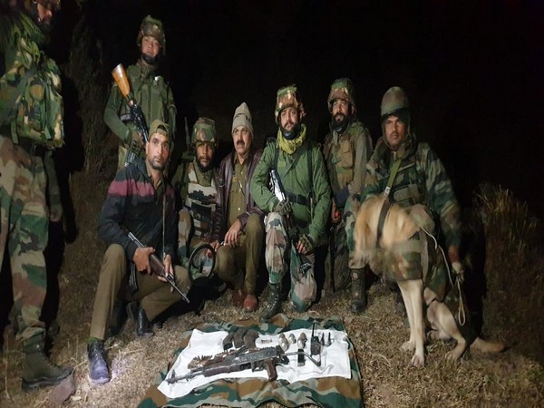 Police personnel along with the recovered arms and ammunition.
