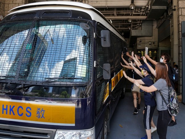 Supporters bid farewell to a prison van transporting Tong Ying-kit, 