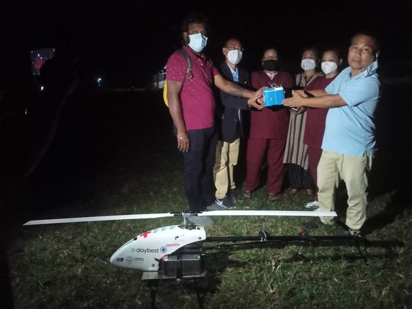 Visual of officials with the drone after completing its first delivery in Manipur.