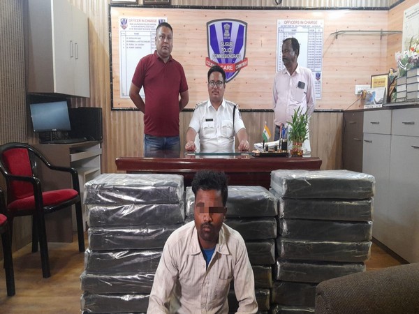The accused driver and the 20 nylon packets containing 208 Kg Ganja. [Photyo/ANI]