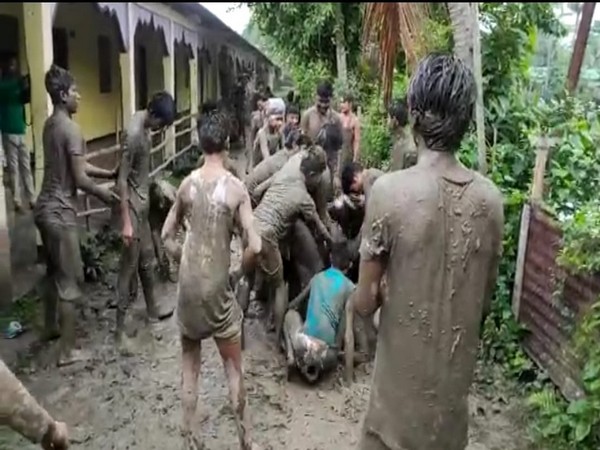 People in Assam's Majuli play in the mud as they celebrate Rongali Bihu on Friday. [Photo/ANI]