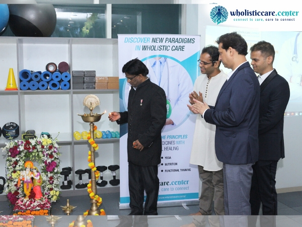  Dr John Ebnezar lighting the auspicious lamp and inaugurating the Wholistic Care Center in Mumbai as Yogi Sakha, Dr Pradeep Singh (centre) and Dr Saurabh Talekar (extreme right) watches.