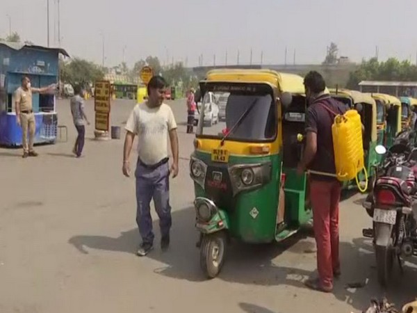 An auto-rickshaw being sanitised at East Vinod Nagar depot on Saturday. Photo/ANI