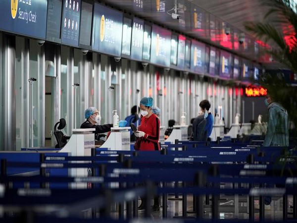Travellers are seen at check-in counters at the Wuhan Tianhe International Airport after travel restrictions to leave Wuhan were lifted