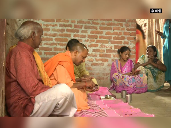 UP Chief Minister Yogi Adithyanath having lunch in Ayodha during his visit to a Dalit Family. Photo: ANI