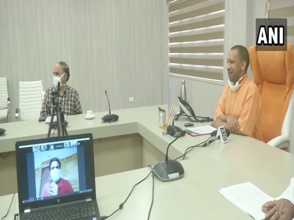 Uttar Pradesh Chief Minister Yogi Adityanath interacting with the labourers via video conference on Friday. Photo/ANI