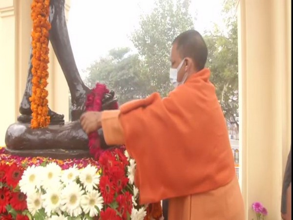 UP CM Yogi Adityanath garlanding the statue of Mahatma Gandhi at Hazratganj