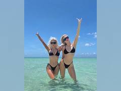 
      
      Sisters Kim, Khloe Kardashian twin in black bikinis
      
      