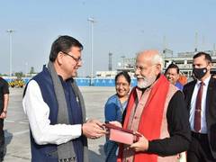
      
      Uttarkhand CM gifts traditional cap to PM Modi
      
      