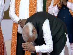 
      
      PM Modi bows before gathering at Patel's swearing-in
      
      
