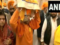 
      
       Yogi Adityanath carries Sikh holy book on Veer Bal Diwas
      
      