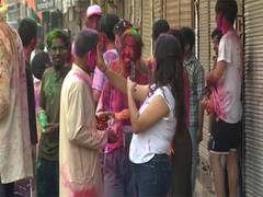
      
      Foreign nationals join locals in Paharganj for Holi celebrations
      
      
