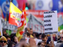 
      
      Demonstrators clash with police as Macron survives pension votes 
      
      