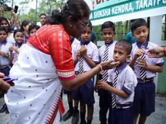 
      
      President Murmu gets down from vehicle midway, greets kids 
      
      