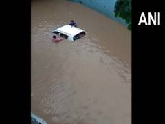 
      
      Gujarat: Car submerged at flooded underpass, occupants rescued
      
      