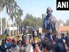 
      
      Opposition protests suspension of 92 MPs infront of Gandhi Statu
      
      