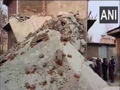 
      
      J-K: Vehicle buried under debris after building collapses
      
      