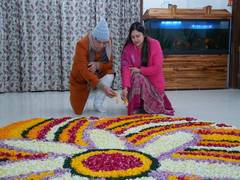 
      
      CM Dhami along with his wife make rangoli of flowers
      
      