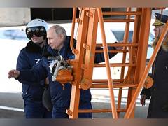 
      
      Russian President Putin flies nuclear-capable bomber
      
      