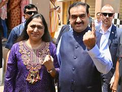 
      
      Adani casts vote, urges people to vote to 