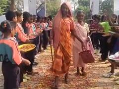 
      
      Elderly voters greeted with flower shower at polling booth
      
      