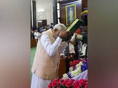 
      
      PM Modi touches Constitution book to forehead
      
      
