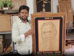 
      
      Woodcraft artist creates wooden portrait for PM-designate Modi
      
      