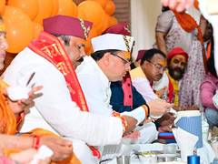 
      
      CM Pushkar Singh Dhami attends community meal with BJP officials
      
      