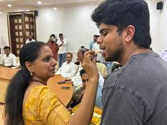 
      
      K Kavitha welcomed with sweets by her son, brother KTR 
      
      