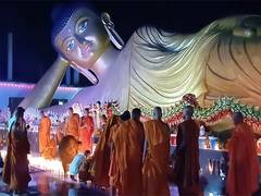
      
      Bihar: Monks light candles near statue of Lord Buddha
      
      