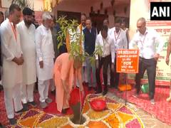 
      
      UP CM plants sapling on Syama Prasad Mookerjee's death anniversa 
      
      