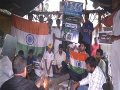 
      
      Indian cricket fans perform prayers for Team India's victory 
      
      