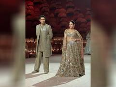 
      
      Sara beams with joy as she walks ramp with bro Ibrahim
      
      