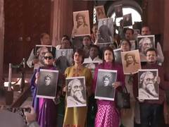
      
      TMC MPs protest against centre with photos of Rabindranath Tagore
      
      