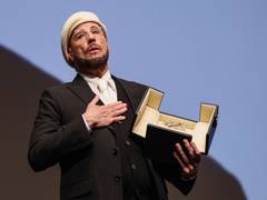 
      
      John Travolta receives surprise Honorary Palme d’Or at Cannes
      
      