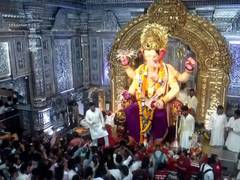 
      
      Devotees throng Mumbai's Lalbaugcha Raja to offer prayers during
      
      