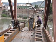 
      
      Re-construction of battered wooden footbridge in Baramulla...
      
      