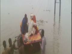 
      
      Bihar: Newlyweds use makeshift boat to cross flooded road
      
      
